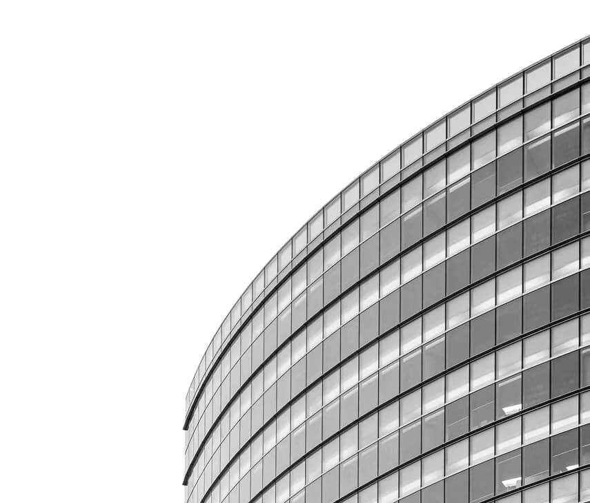 The curved glass front of an office building.